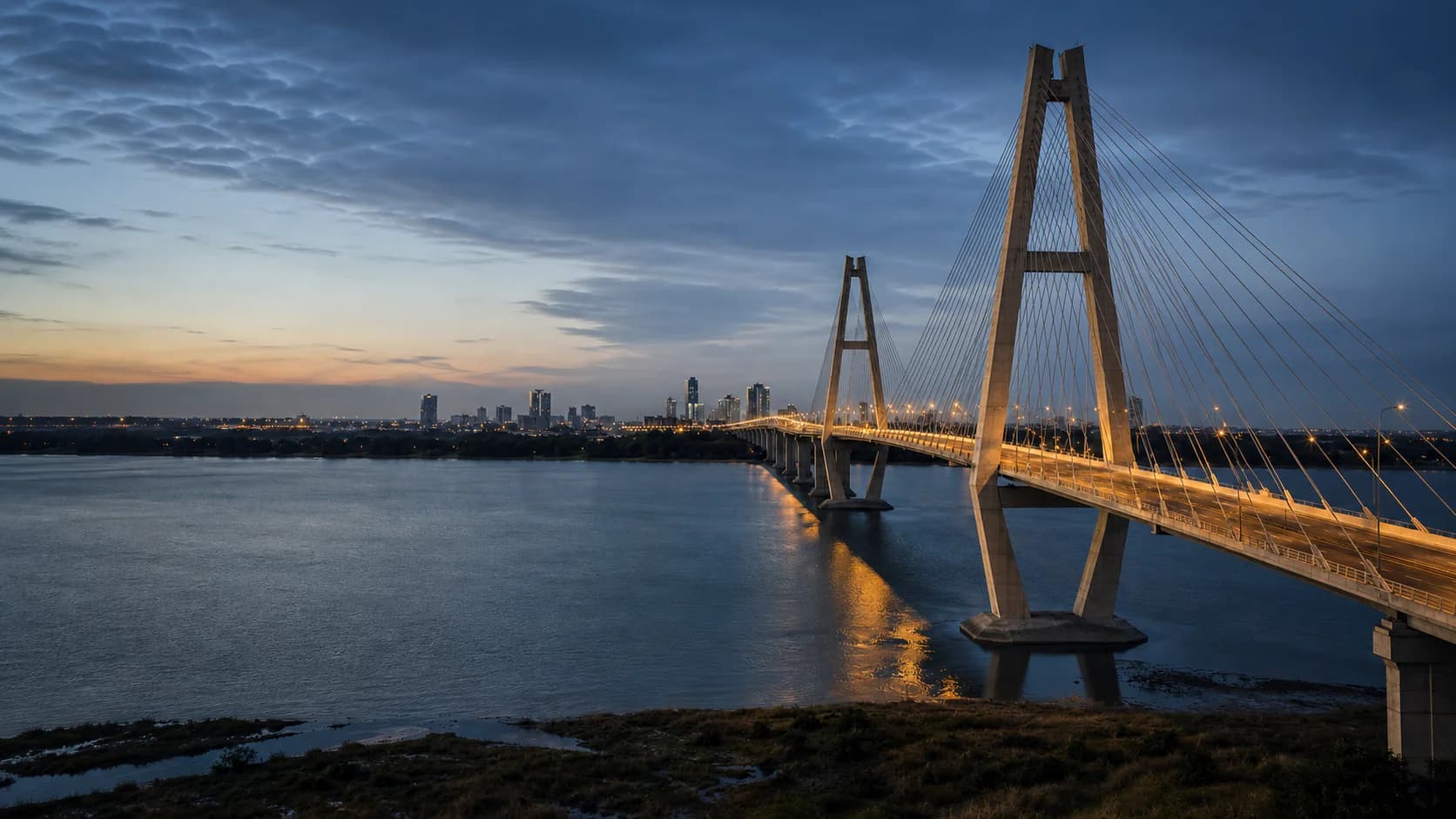 Cable-stayed bridge connecting an African city at dusk